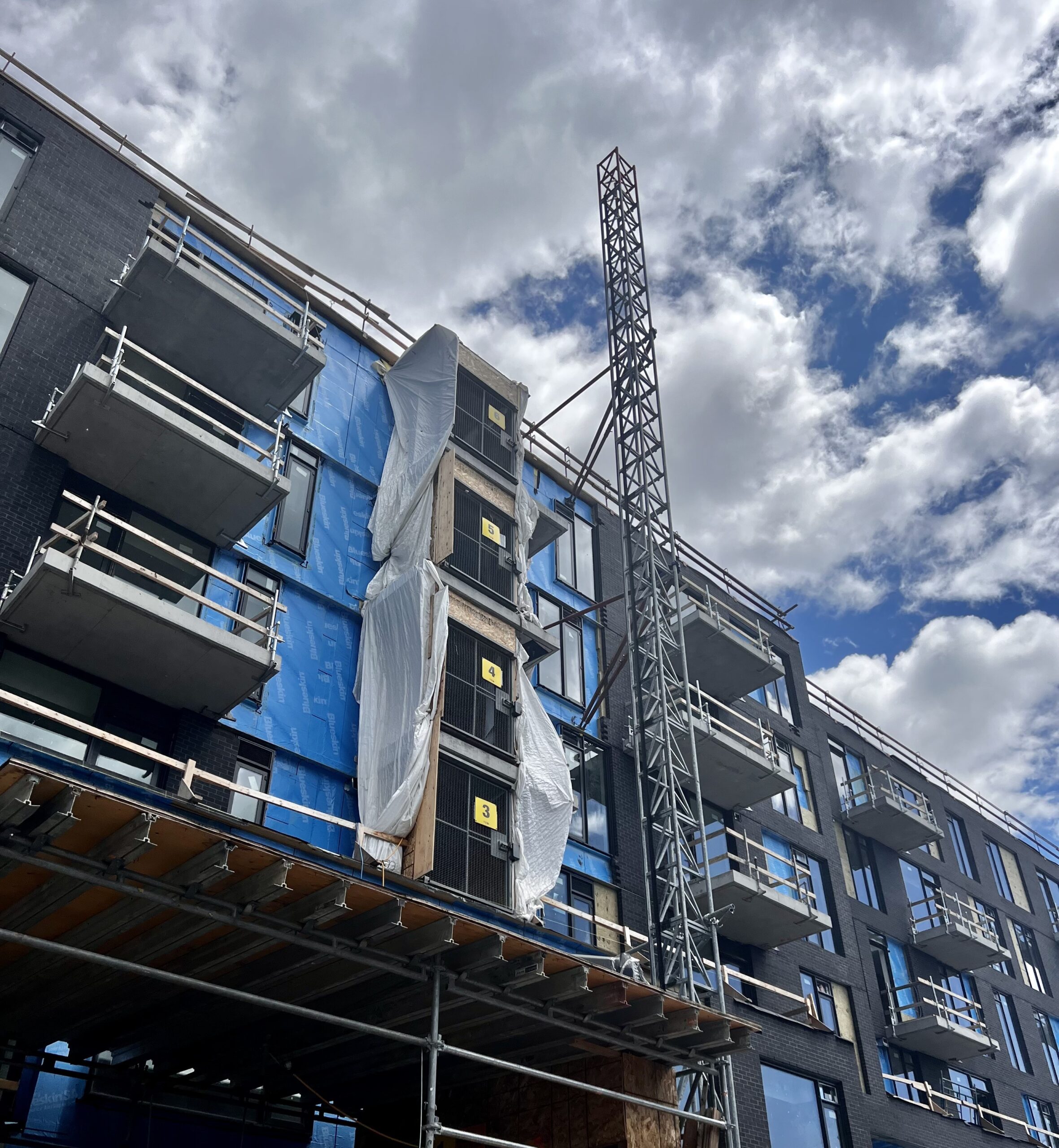 YSB Hoist scaling side of new building.